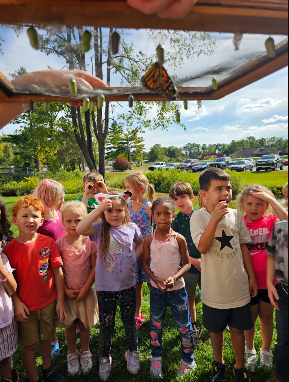 Grace students observing butterflies and exploring God's creation