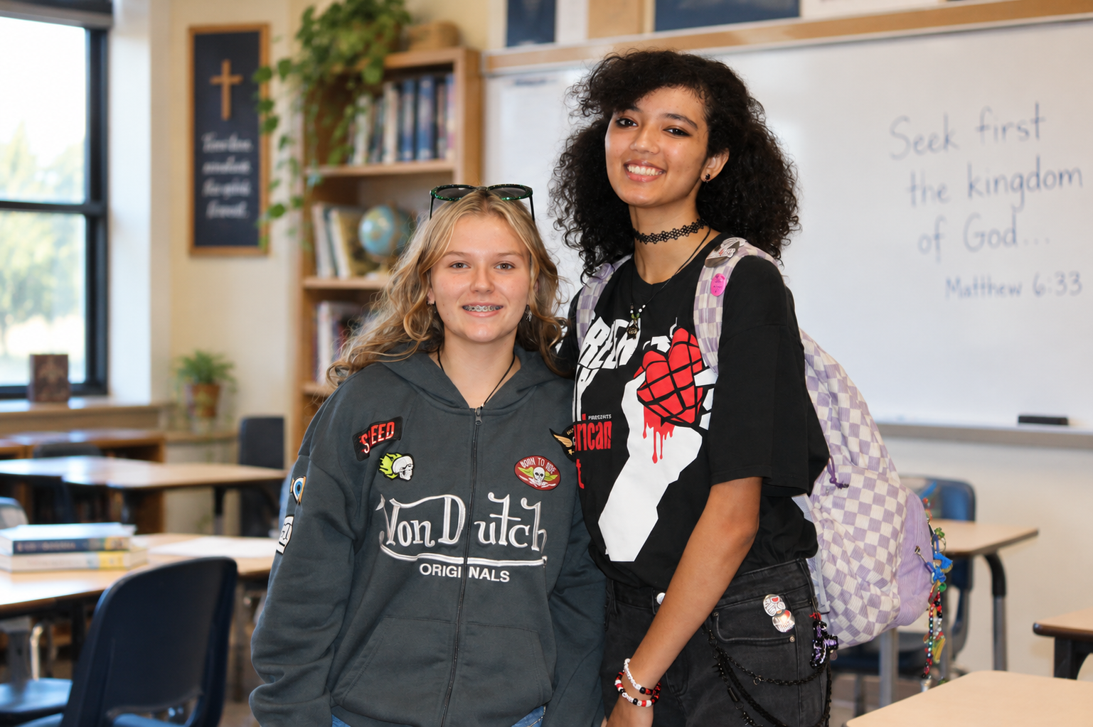 Two Grace Christian School high school students smiling together in a classroom