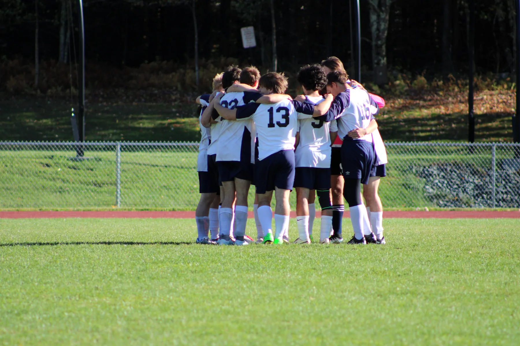 Grace Christian School soccer team huddling together